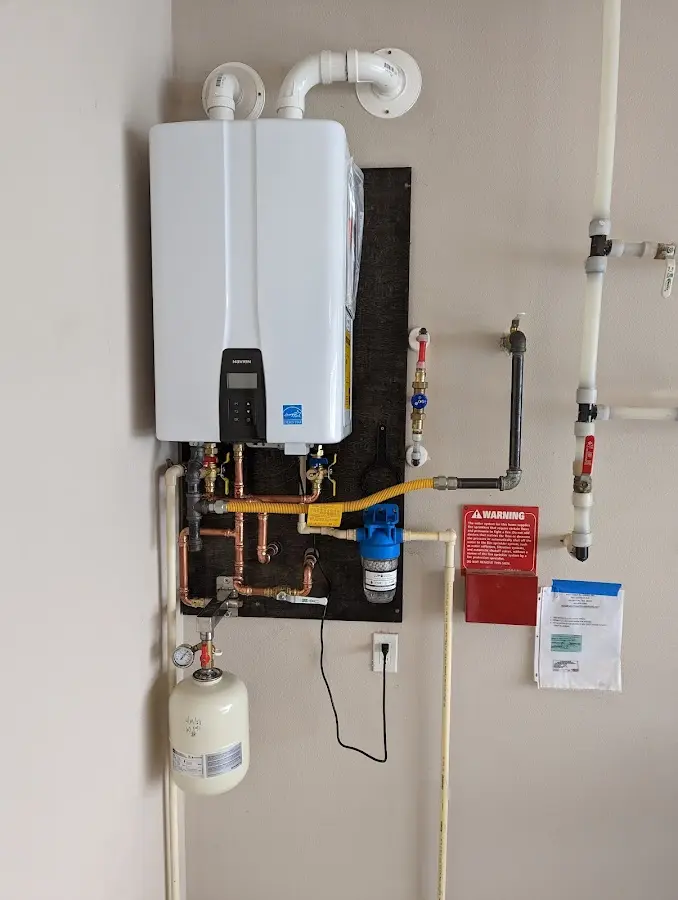 Professional plumber installing copper piping in a Oatfield home